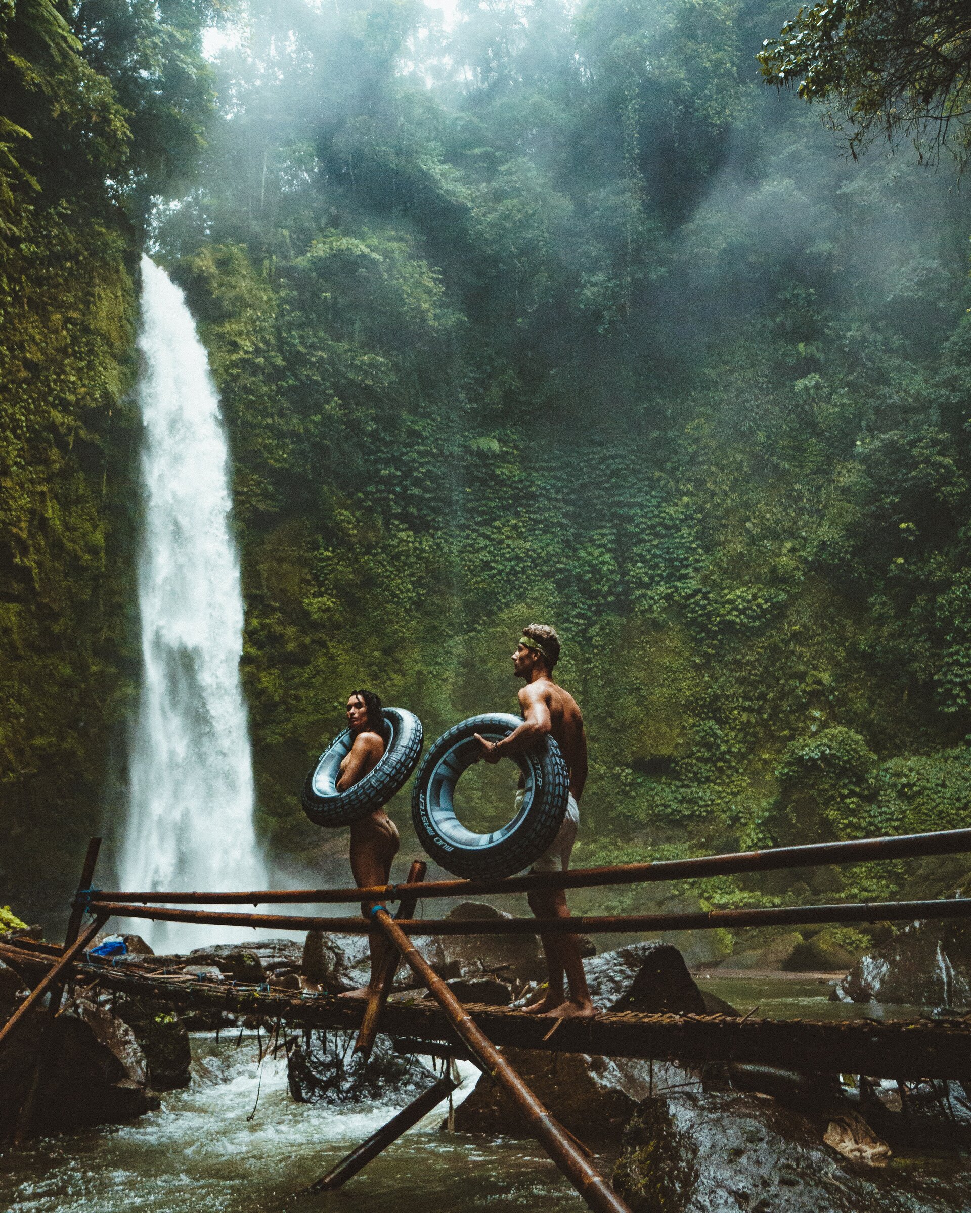 Couple standing by waterfall