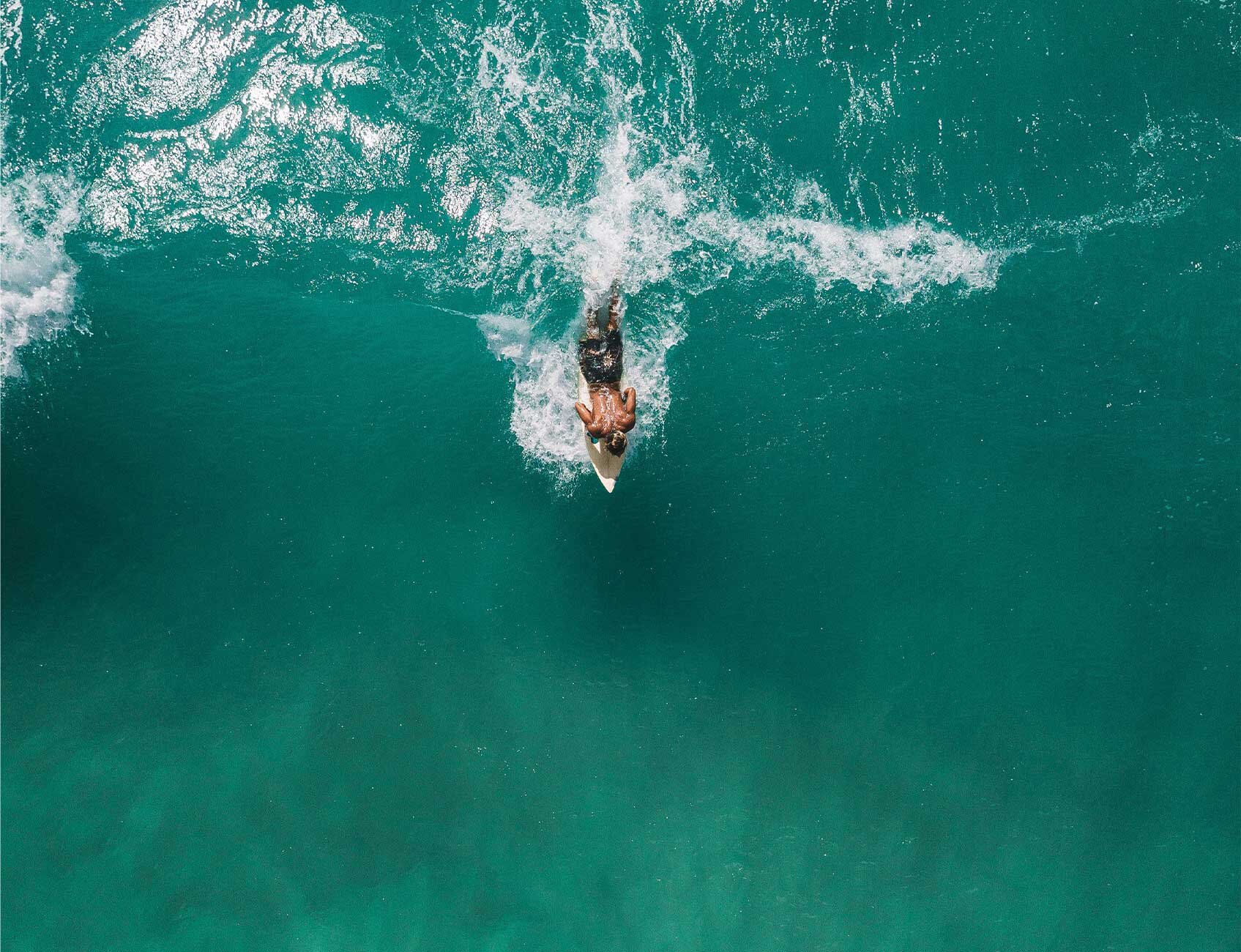 man surfing arial view