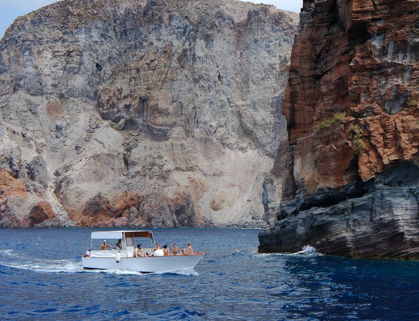 Boat tour near rocky cliffs